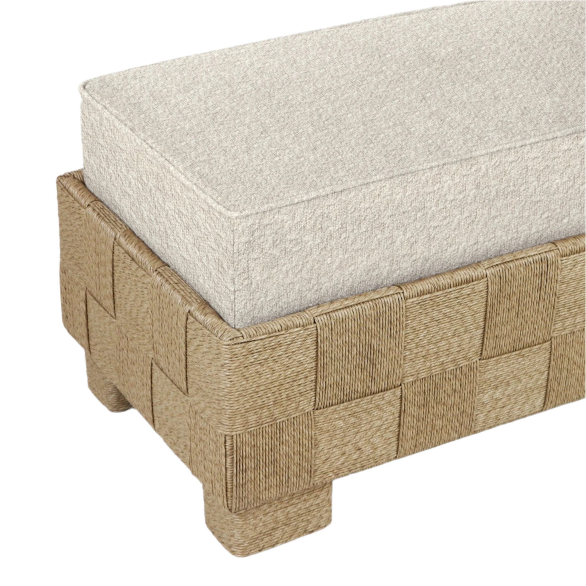 Close-up of a beige boucle upholstered seat cushion resting on a woven natural seagrass base with block-style feet, showing the corner detail of a modern end-of-bed bench.