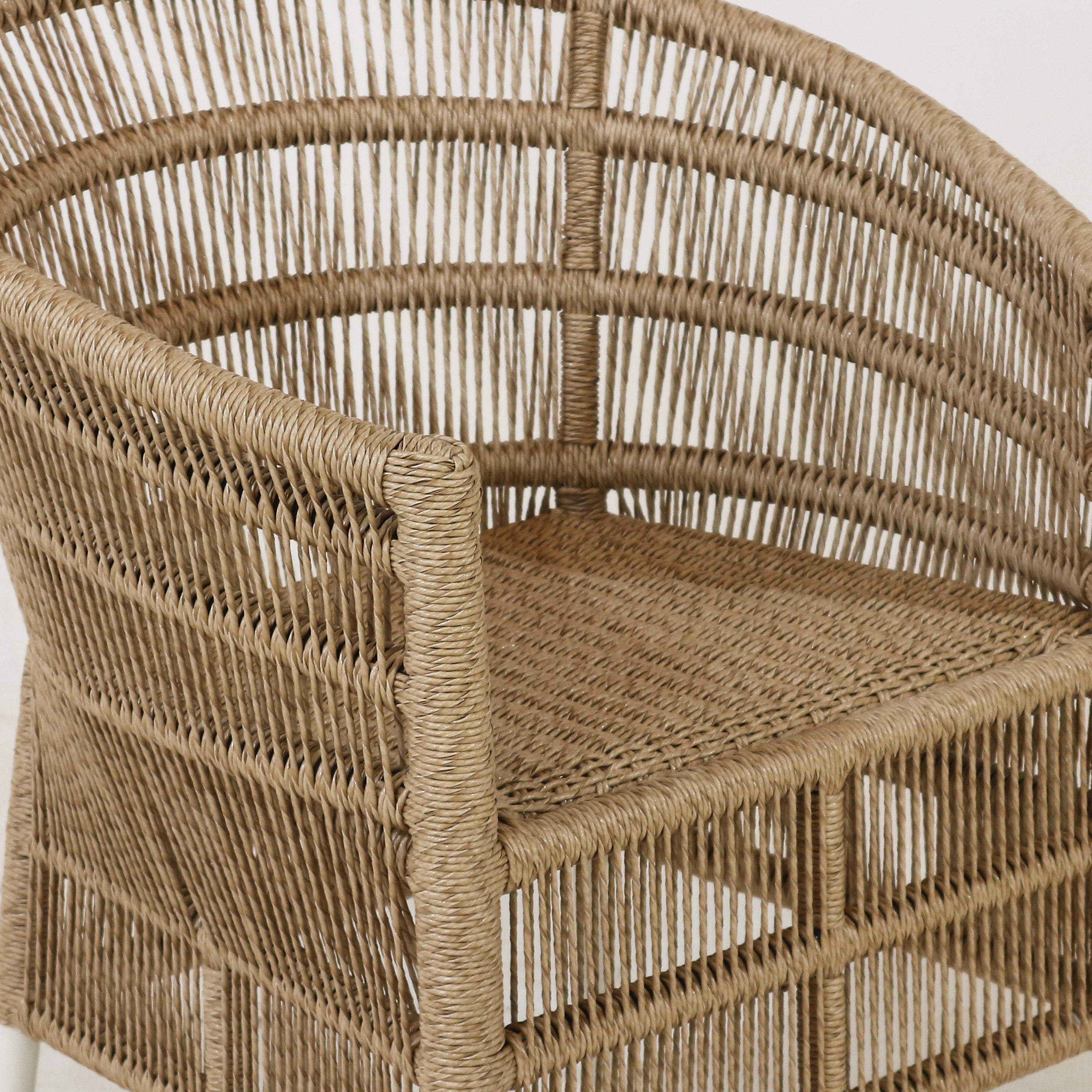 Close-up of a wicker chair with a neutral background. interiortonic.com Sirena outdoor patio chair