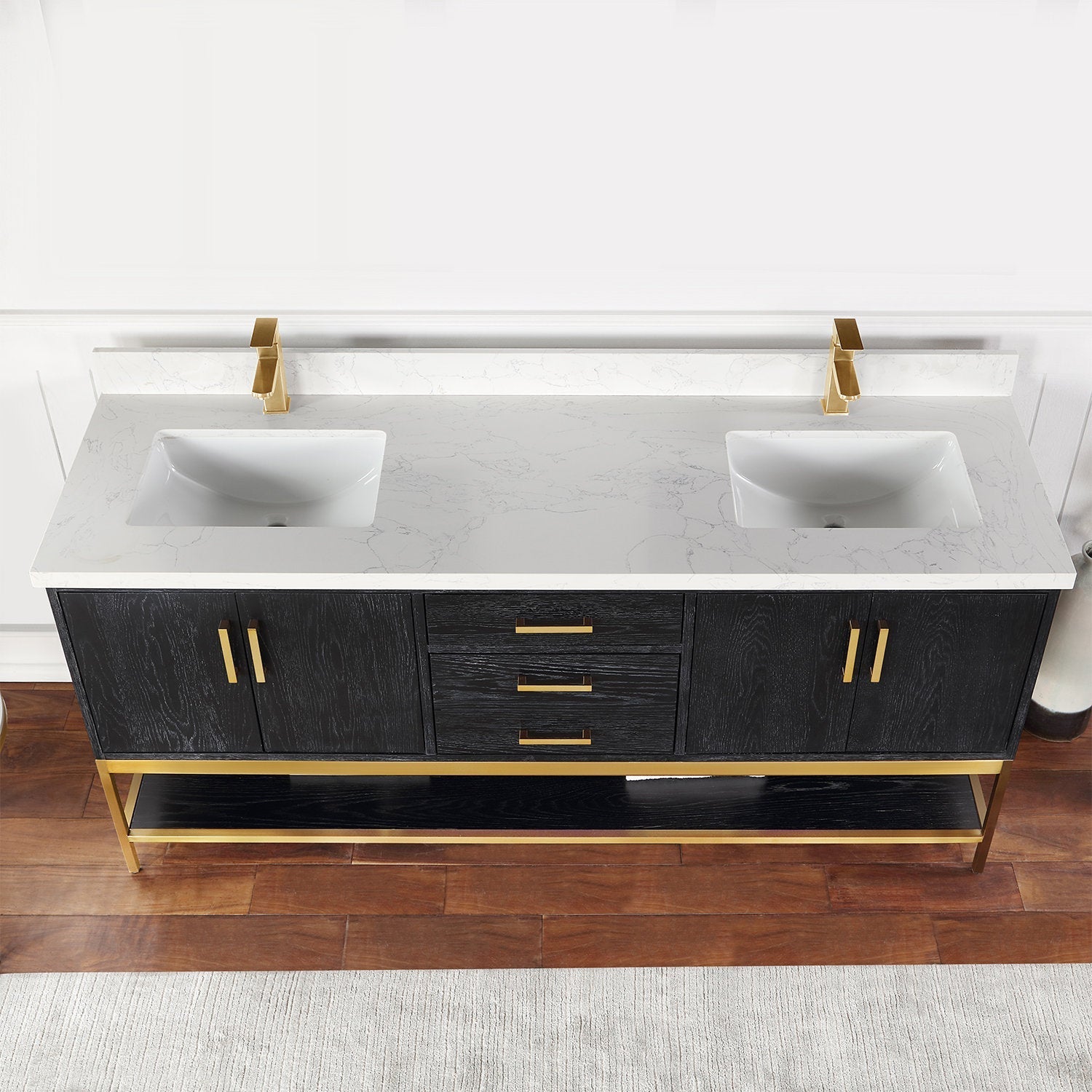 Modern 72-inch freestanding double-sink vanity with a stone-colored marbled top, two rectangular ceramic undermount sinks, black solid wood base, gold faucets and hardware, and an open lower shelf.