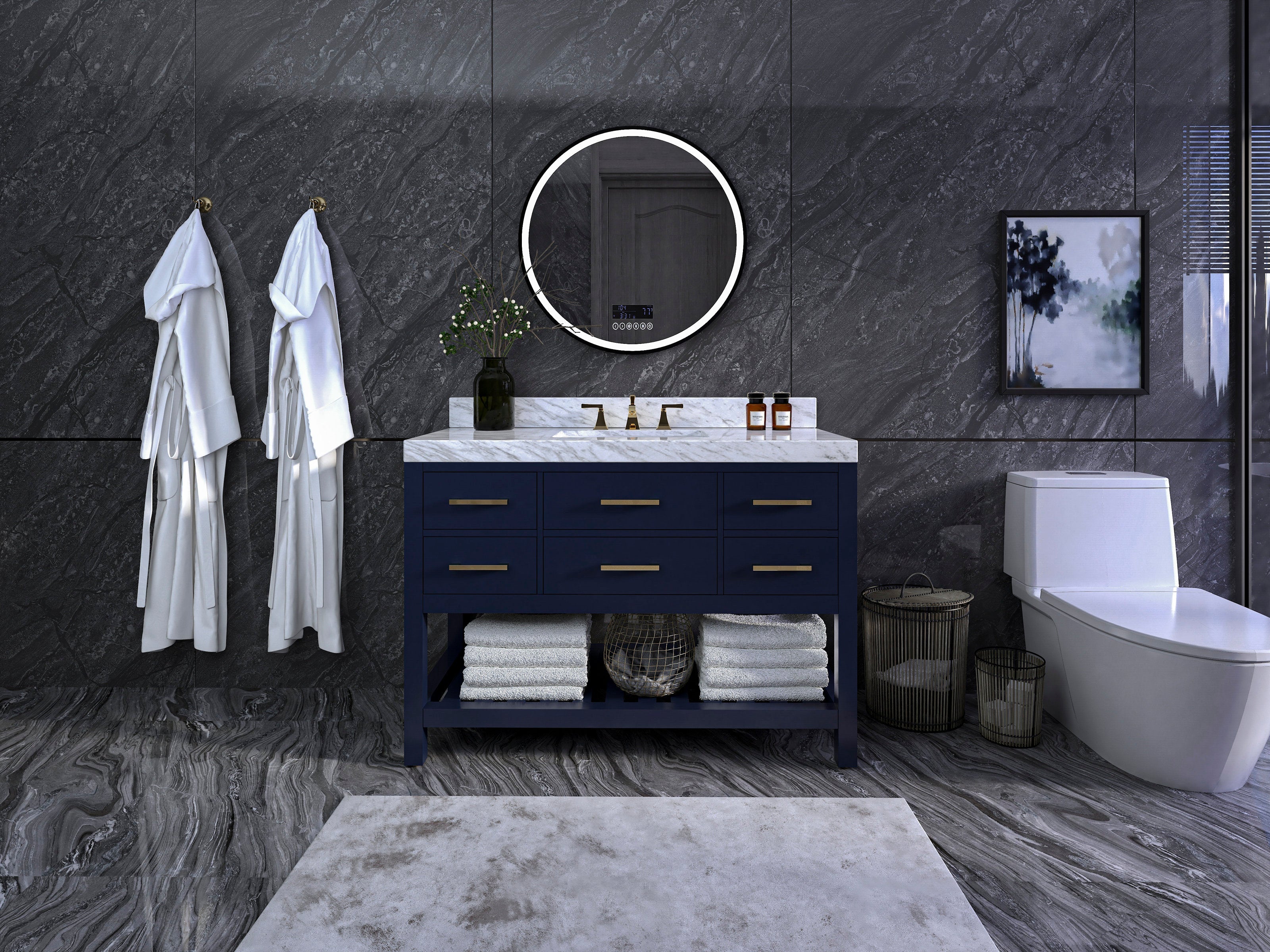 48-inch single-sink navy solid-wood vanity with white marble countertop, brass faucets and drawer pulls, round illuminated mirror above, folded towels on open shelf and two white robes hanging on dark stone wall.