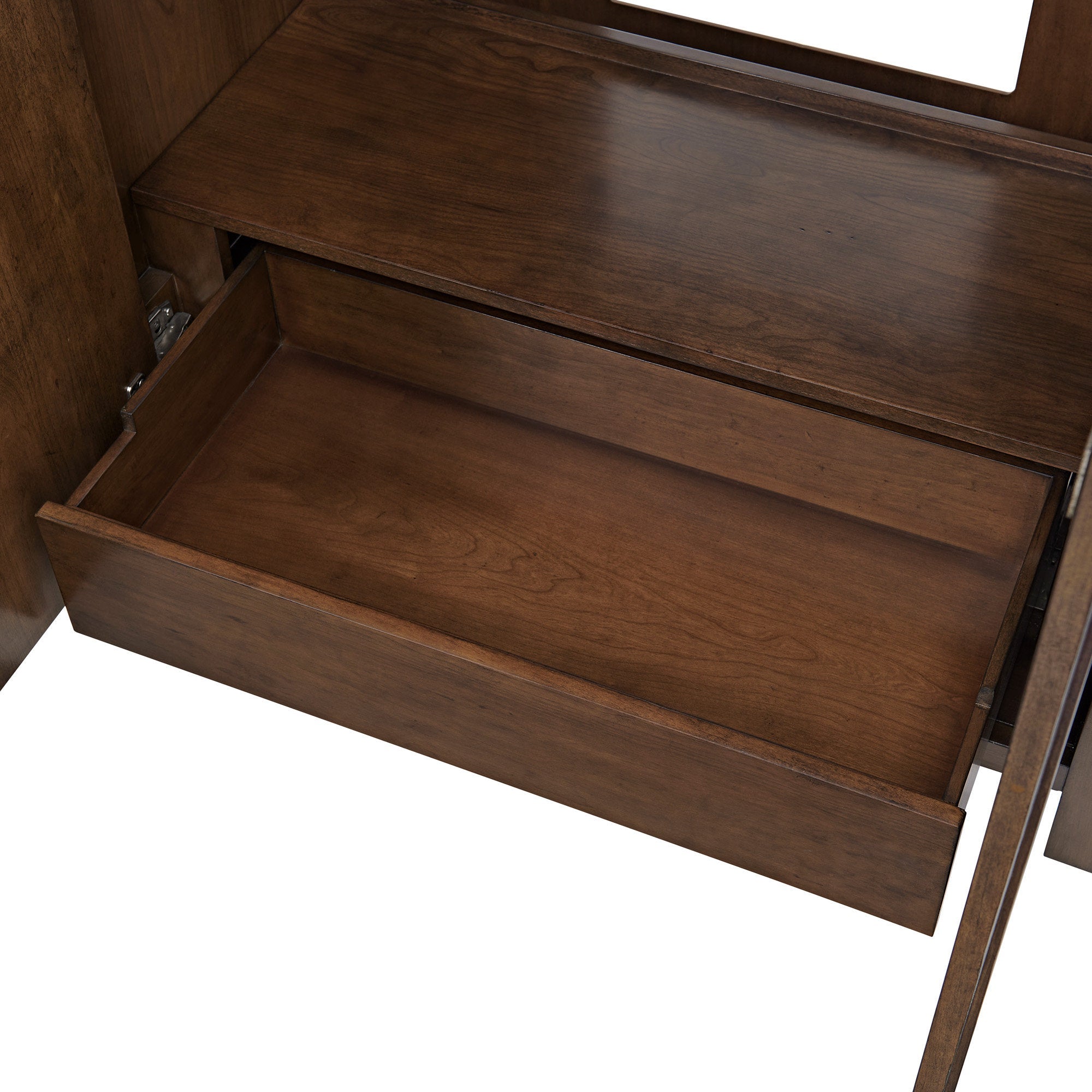 Open solid wood storage drawer inside a modern stone-colored bathroom vanity, revealing warm natural wood grain, smooth interior base and visible hinge hardware for soft-close operation.