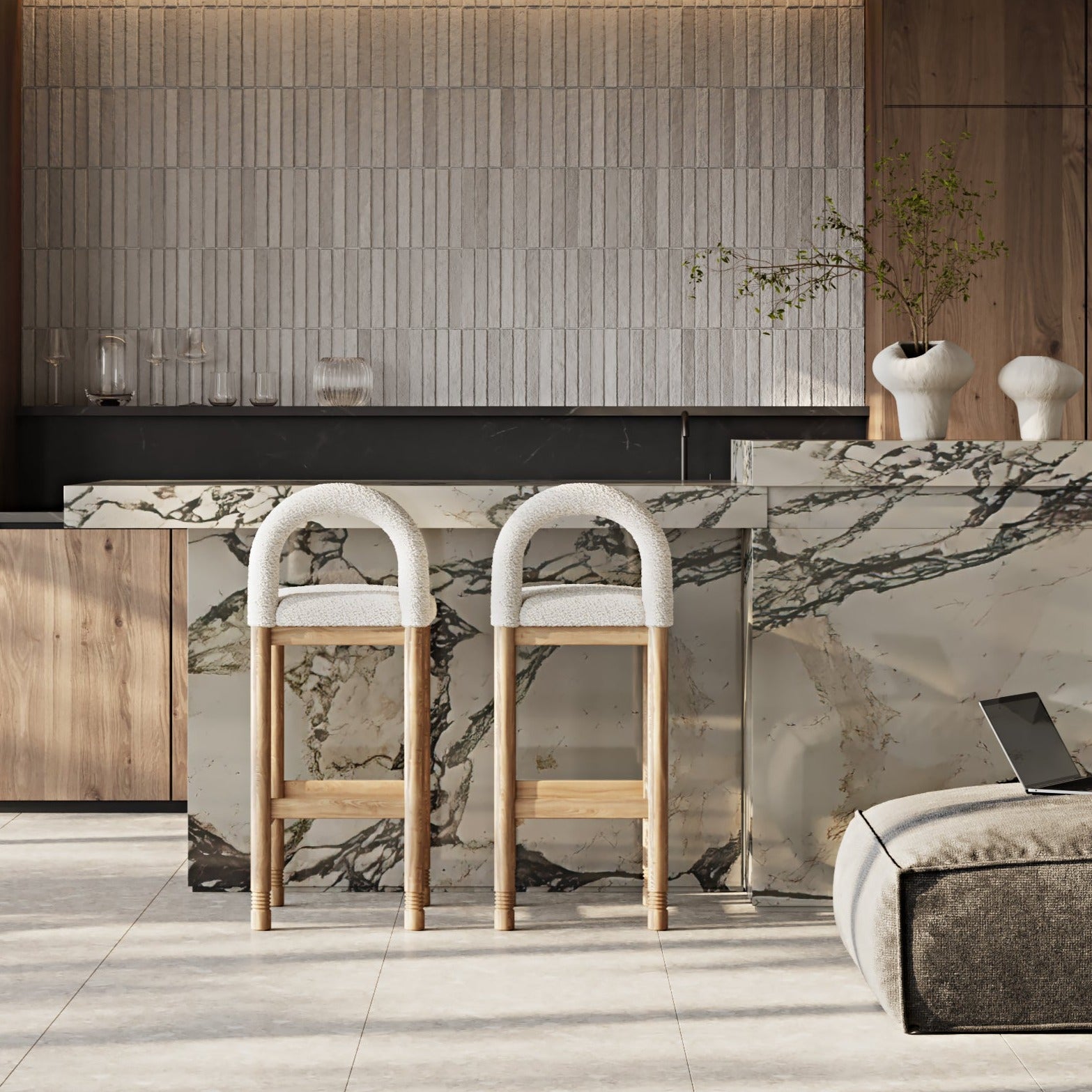 Two beige boucle bar stools with arched backs and natural oak legs sit at a veined marble kitchen island in a contemporary neutral kitchen.