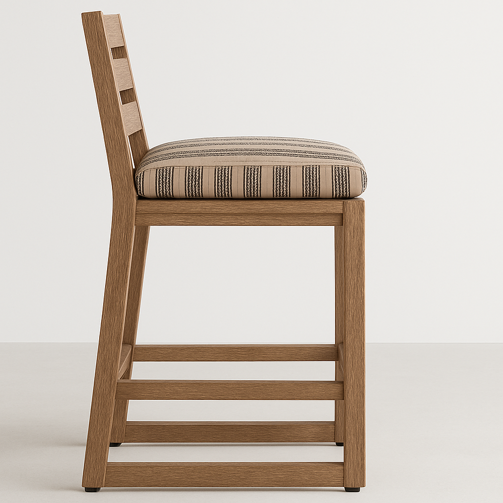 Side profile of an armless outdoor bar stool with a teak frame, ladder-style back and a beige striped upholstered cushion shown against a clean neutral background.