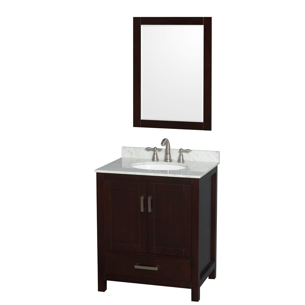 Contemporary dark wood freestanding bathroom vanity with a stone countertop and integrated ceramic sink, brushed nickel faucet and hardware, double-door cabinet with lower drawer, paired with a matching framed mirror.