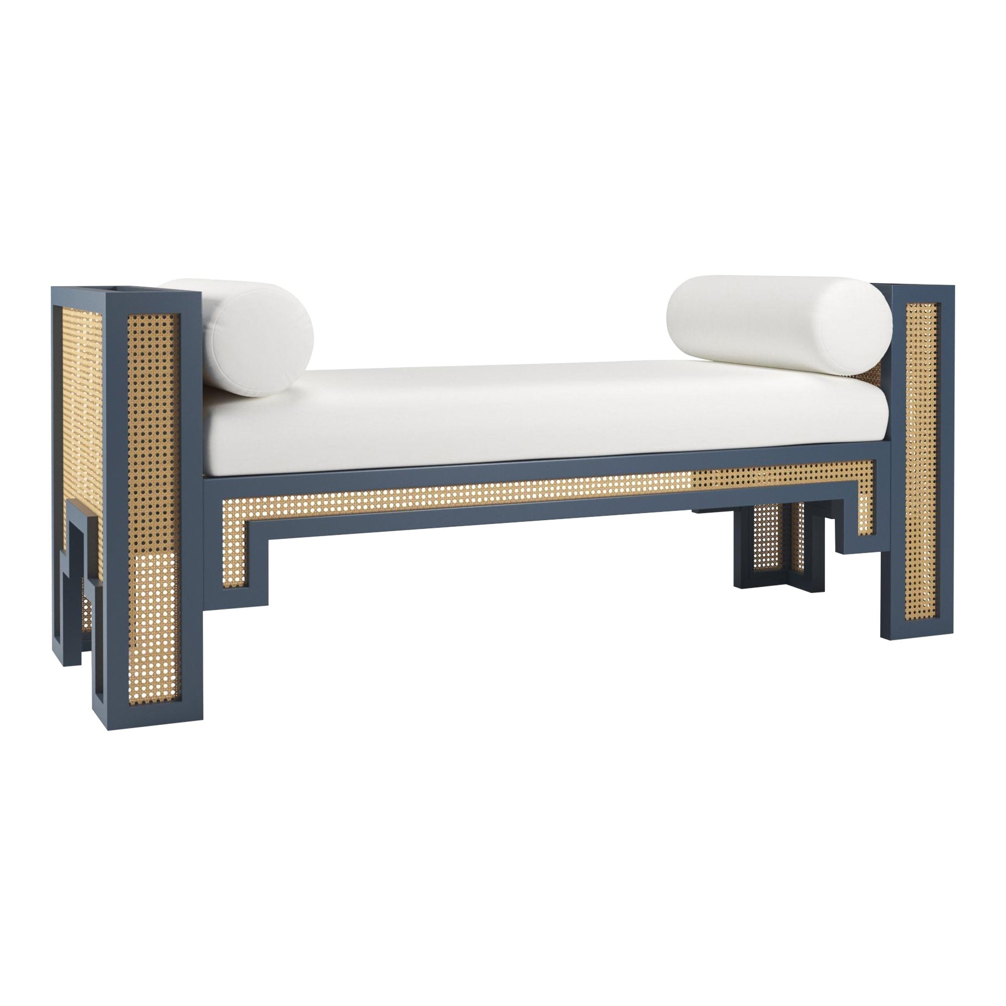 Upholstered 75-inch end-of-bed bench with a white fabric seat and two round bolster pillows, navy-blue wooden frame with natural rattan cane panels and geometric legs in a boho-modern style.