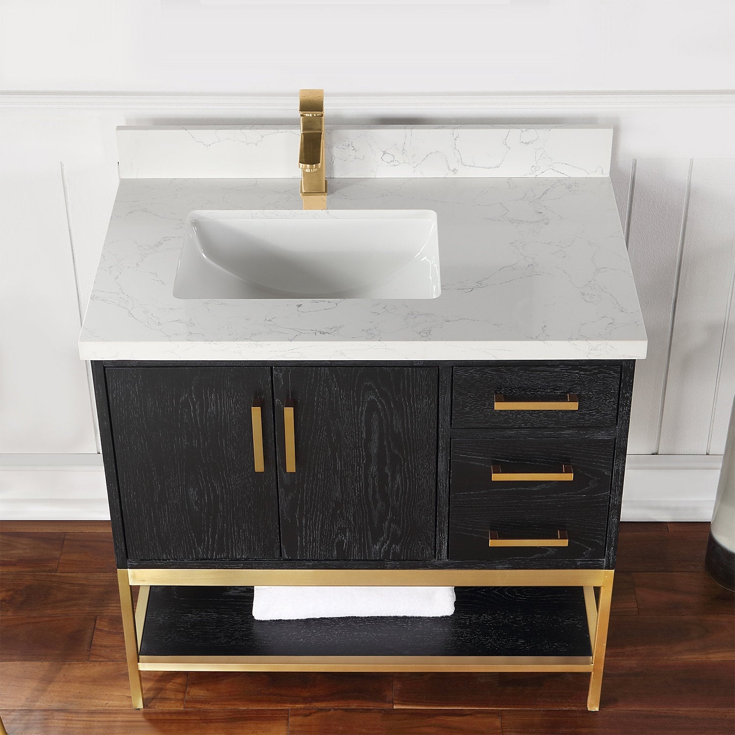 36-inch modern black solid wood bathroom vanity with a white stone countertop and integrated rectangular ceramic sink, brass faucet and matching hardware, three right drawers, double-door cabinet and gold metal open shelf base.
