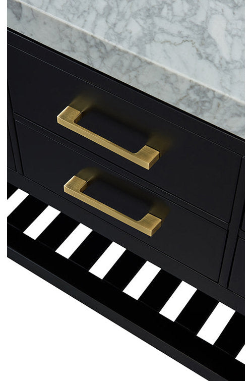 Close-up of a contemporary black solid wood bathroom vanity with a white marble stone top, two brushed brass rectangular drawer pulls and a black slatted open shelf beneath.