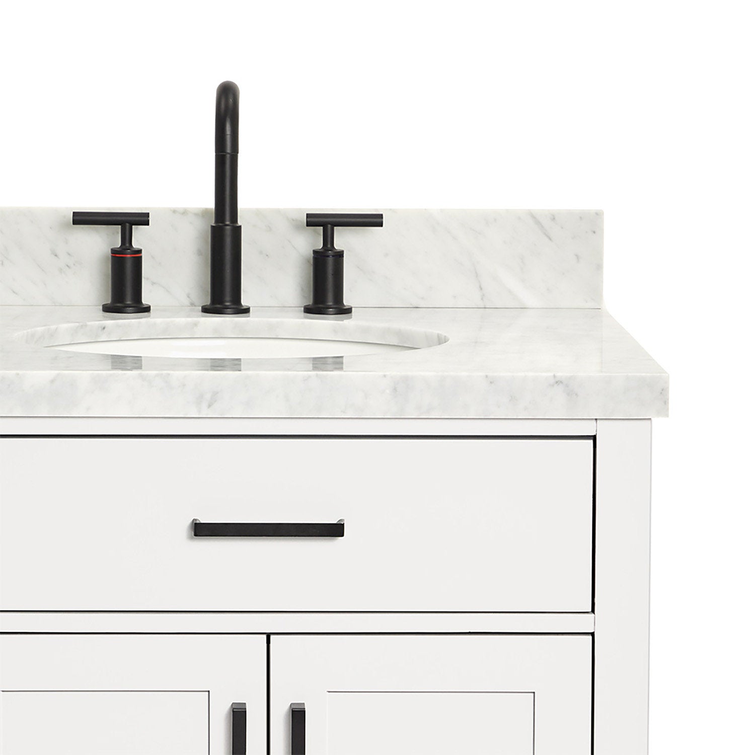 Close-up of a white wooden bathroom vanity with a stone marble top and backsplash, oval undermount sink, matte black three-piece faucet, and matching black drawer and door handles.