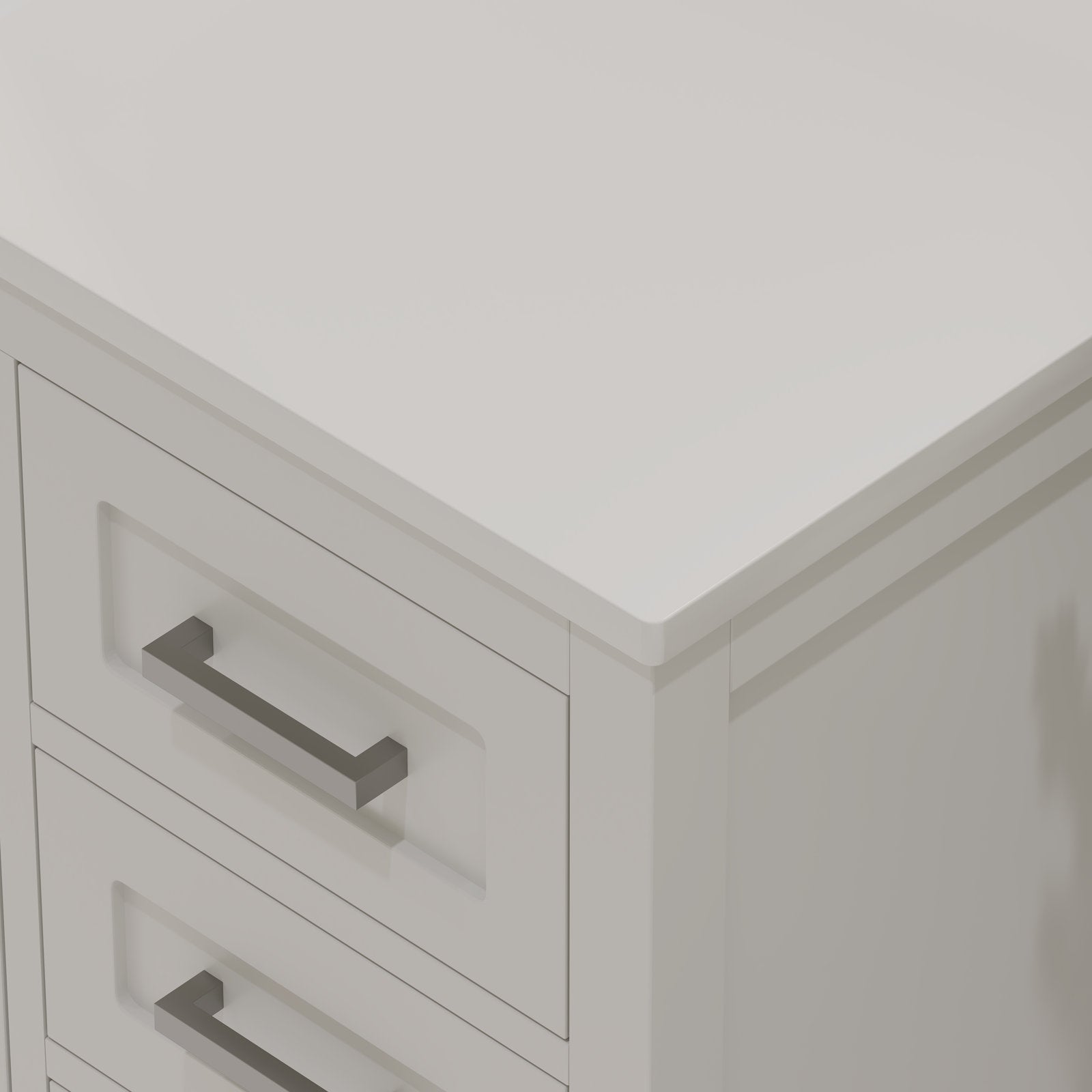 Close-up of a stone-colored solid wood bathroom vanity corner showing a smooth stone top with a rounded edge, inset drawer fronts and rectangular brushed metal handles in a modern contemporary style.