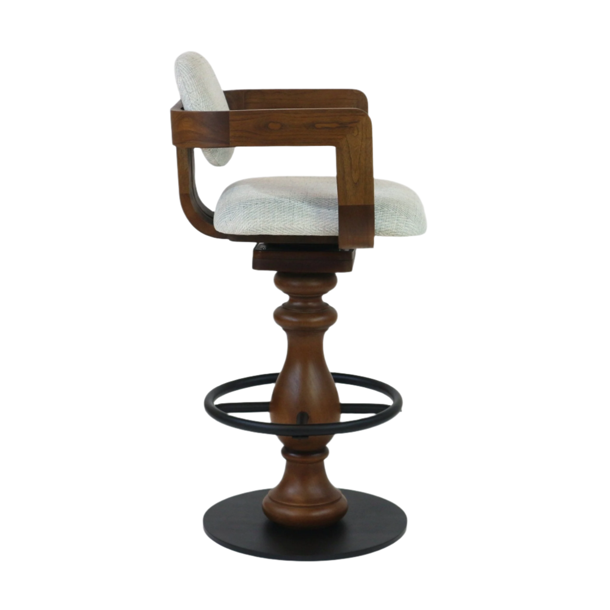 Side view of a light gray upholstered swivel bar stool with curved teak-finish wooden arms and small rounded back cushion, turned natural-wood pedestal, black metal circular footrest and round black base.