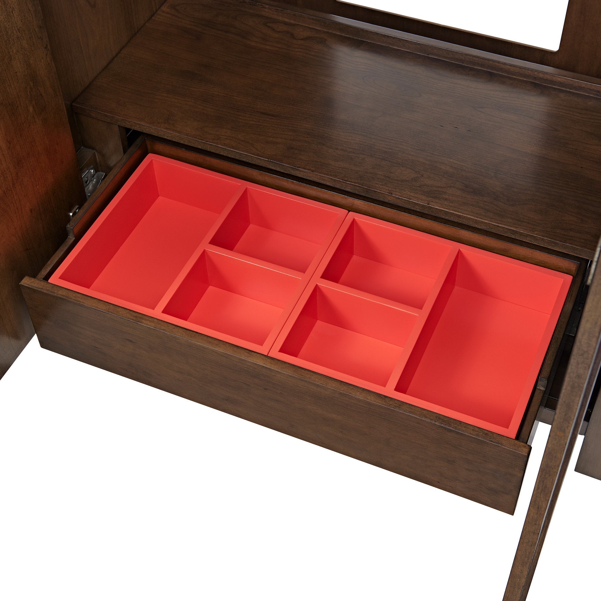 Open solid wood bathroom vanity drawer with a bright red six-section organizer tray, showing warm brown wood grain and divided compartments for storing toiletries and small bathroom items.