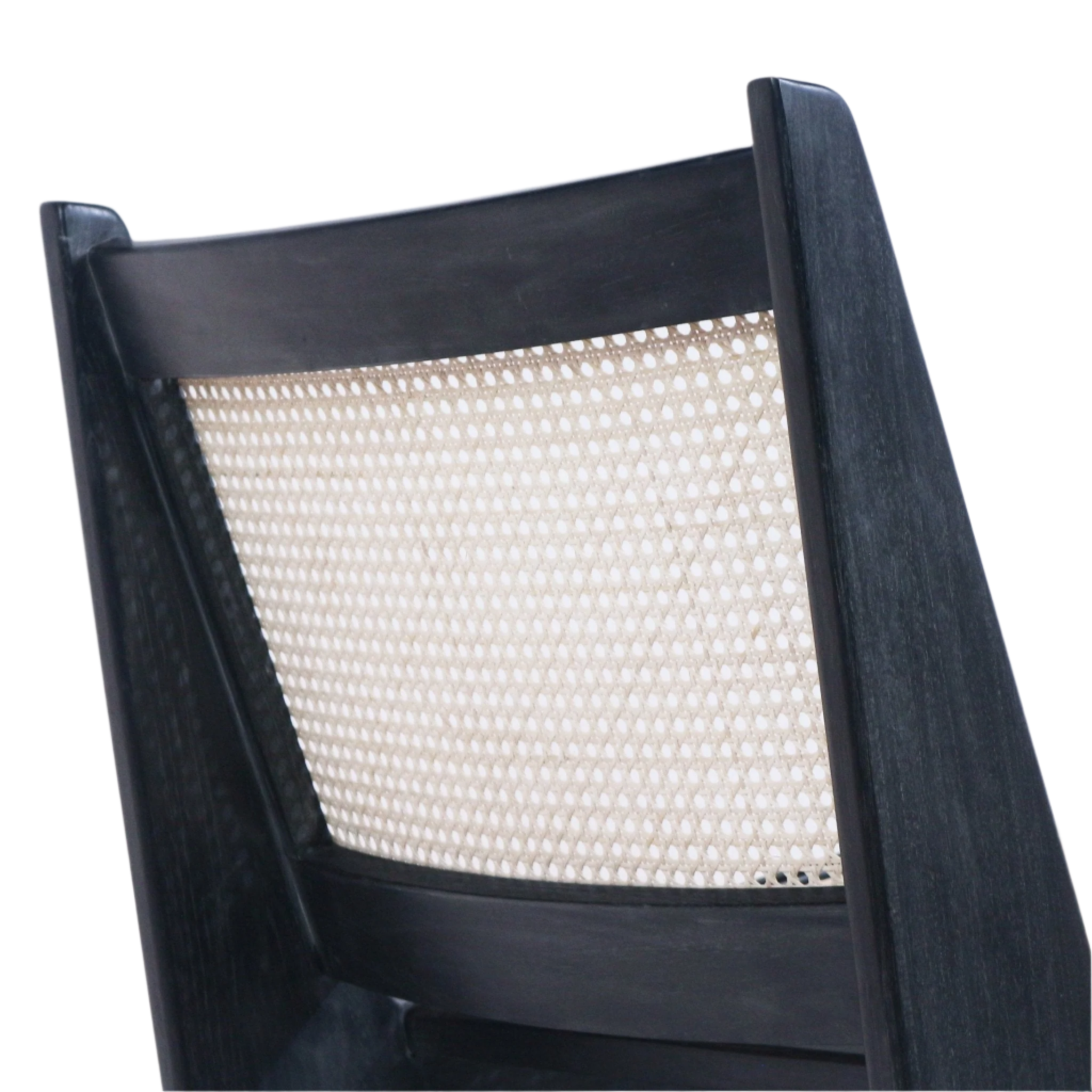 Close-up of a lounge chair back featuring a natural woven cane panel framed by a smoked black solid teak wood frame, highlighting the mid-century modern low-back angled profile.