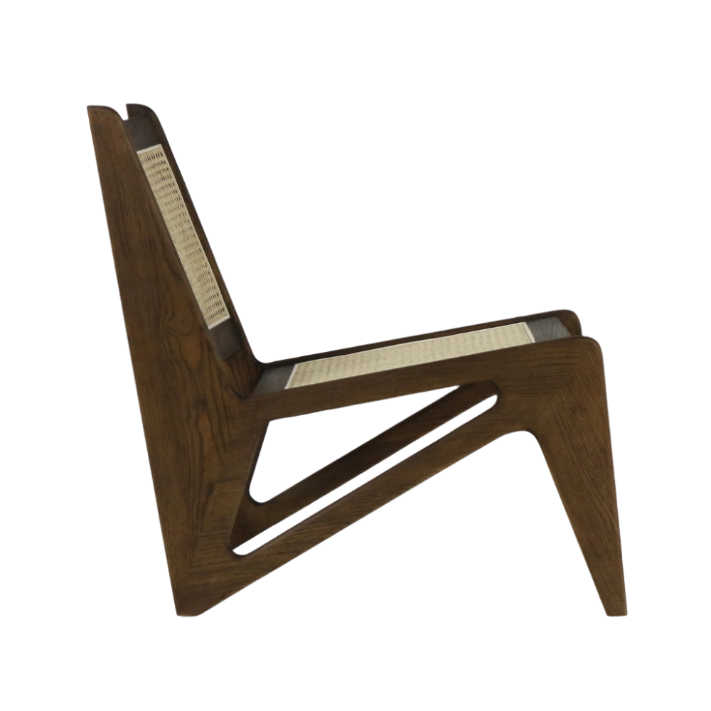 Side profile of a low teak lounge chair with sculpted solid-wood frame and woven cane seat and back, showing the mid-century modern kangaroo-style silhouette on a white background.