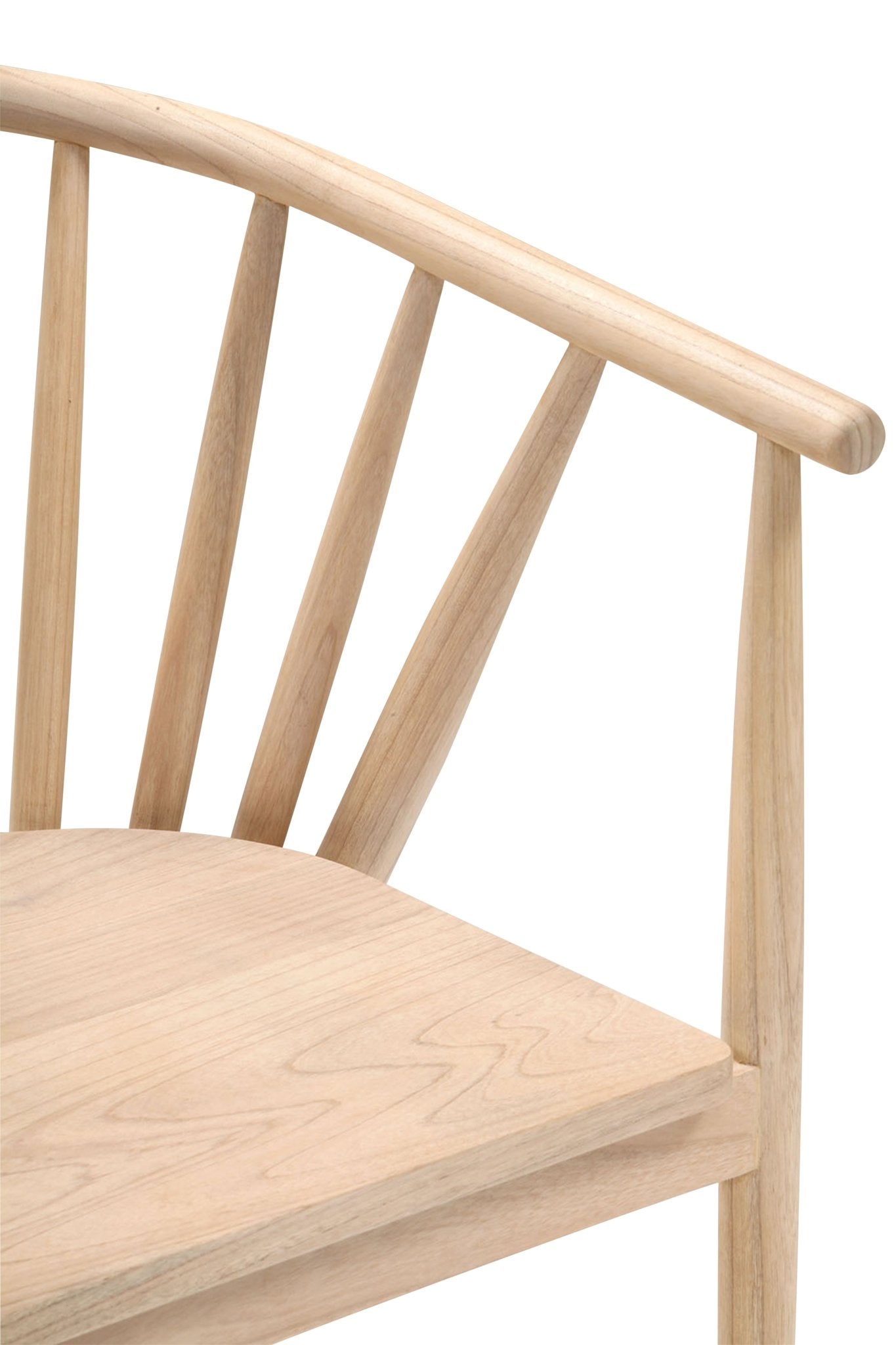 Close-up of a natural teak mid-century modern dining chair showing a curved top rail, vertical tapered spindles and the corner of a smooth wooden seat in a light teak finish.