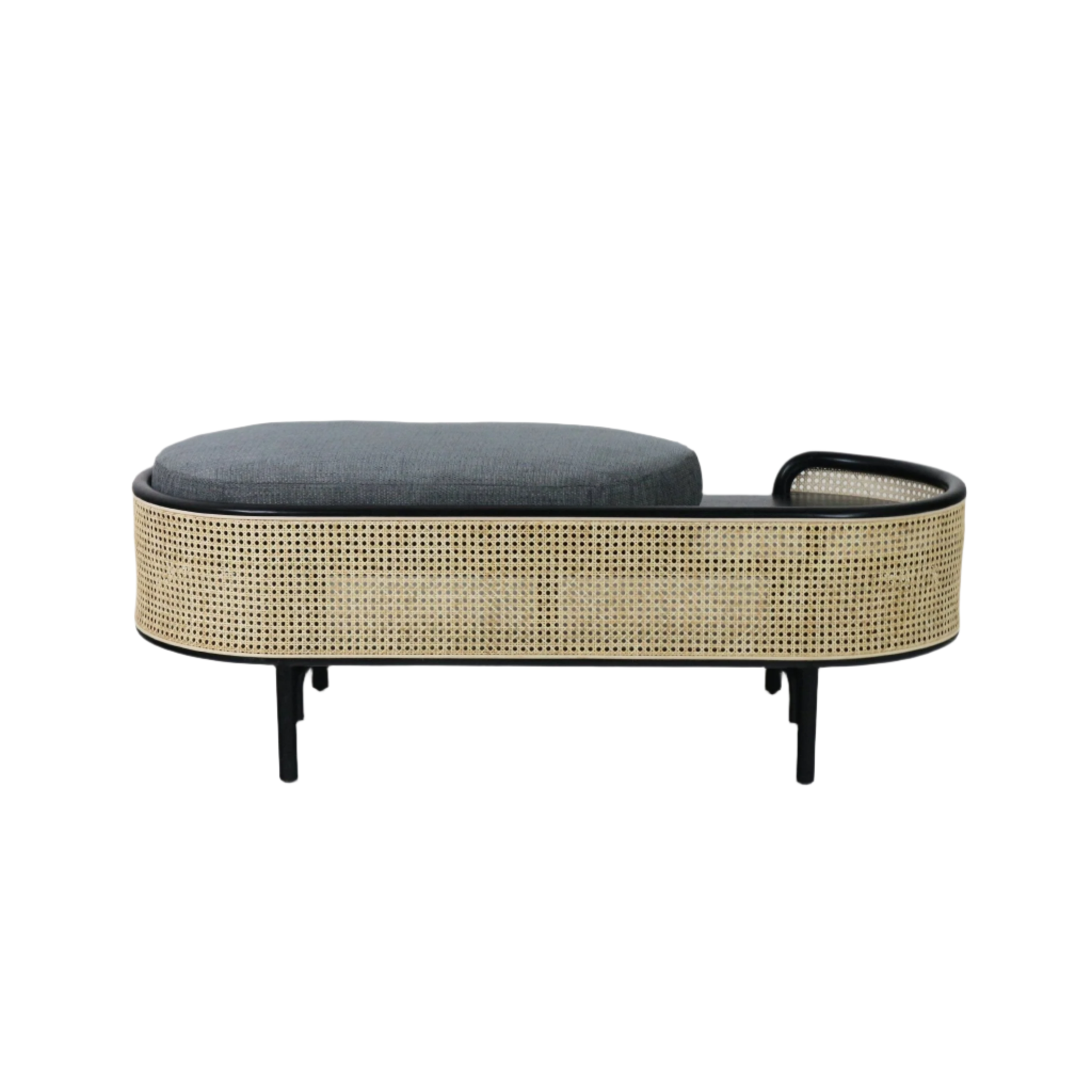 Oval solid wood bench with natural woven rattan sides, black wood frame and legs, topped with a gray fabric cushion and a small curved end handle for a boho-modern indoor seating piece.
