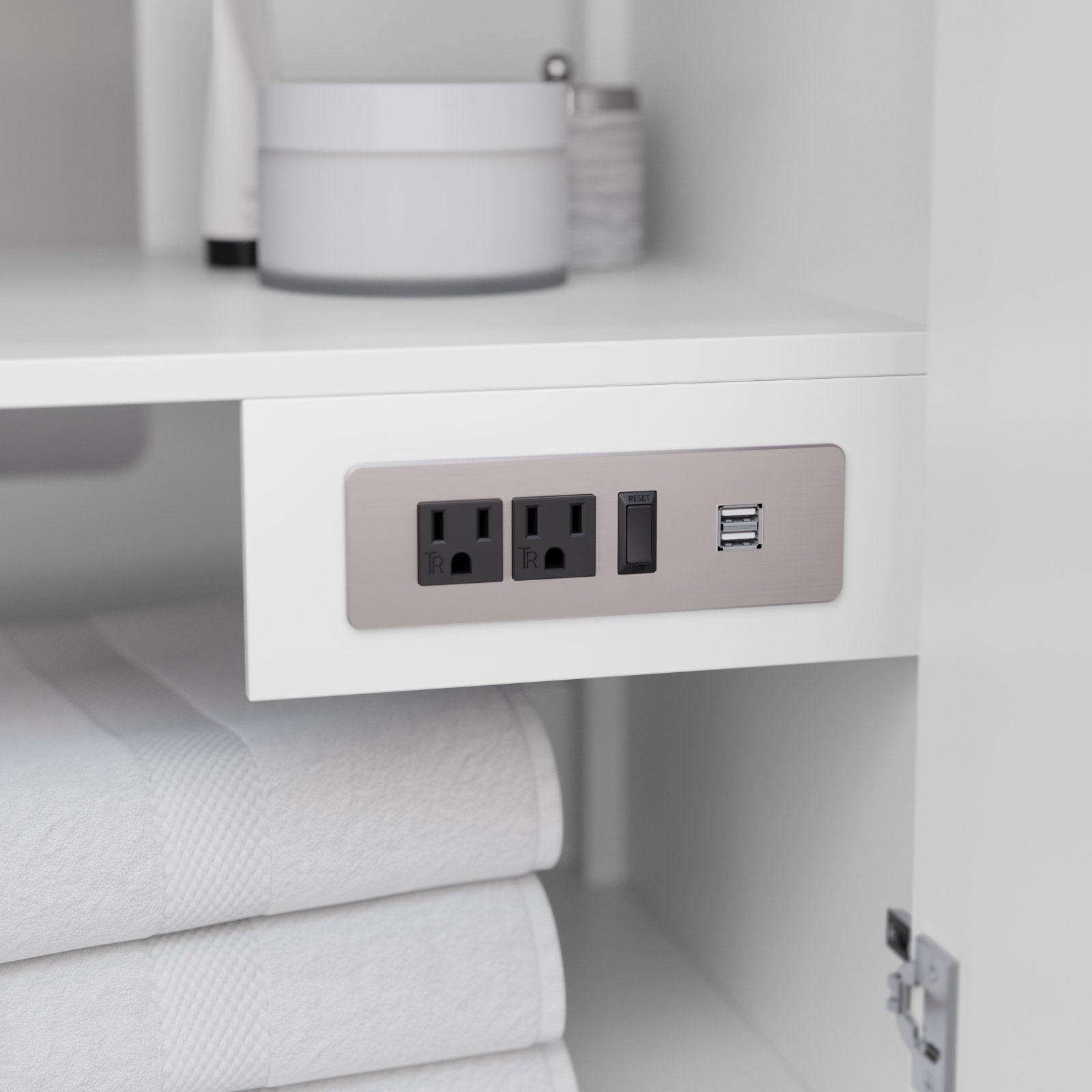 Close-up of a modern solid wood vanity in stone finish showing a built-in power panel with two grounded outlets, reset switch and dual USB ports, with white folded towels below and toiletries on the upper shelf.