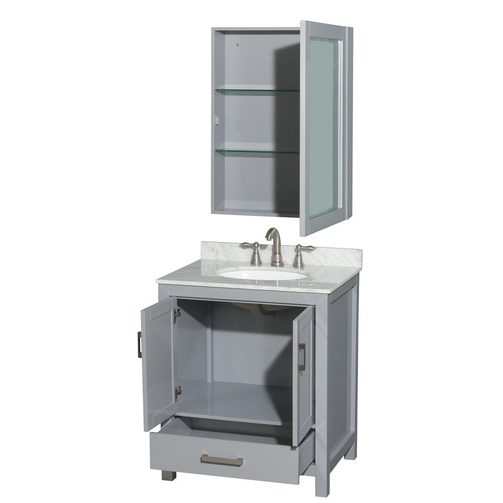 Modern gray solid-wood bathroom vanity with a stone countertop and integrated white ceramic sink, brushed-nickel faucet, open lower cabinet and drawer, plus a matching wall-mounted medicine cabinet with glass shelves.